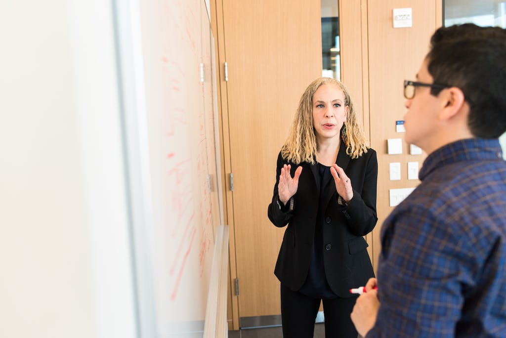 Woman Standing Near Whiteboard